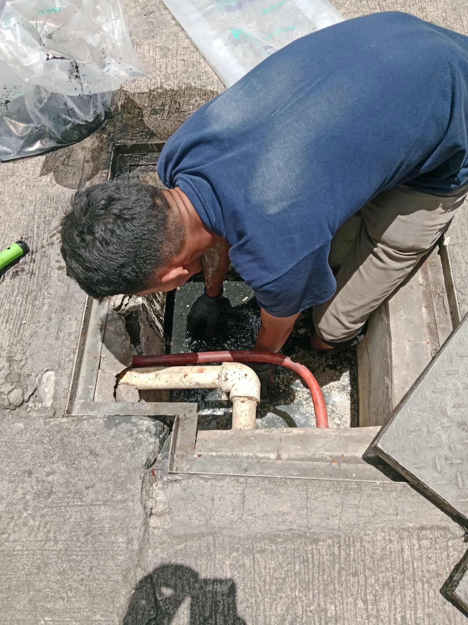Manual cleaning of an accessible drainage channel to remove accumulated debris